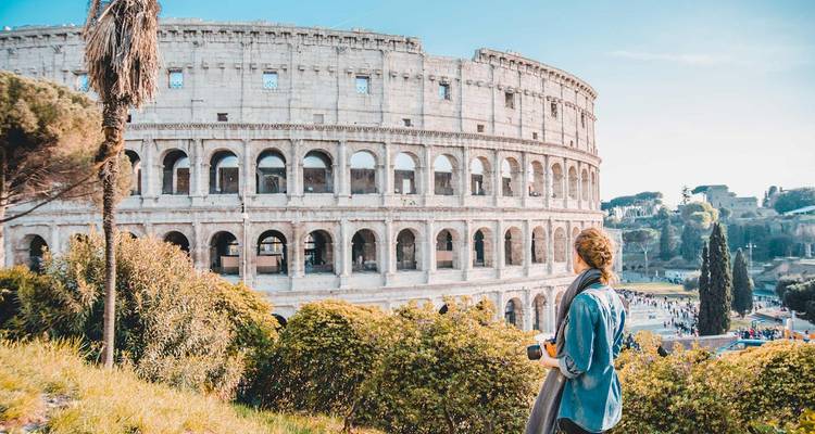 View of the Colosseum with a person enjoying the sight.