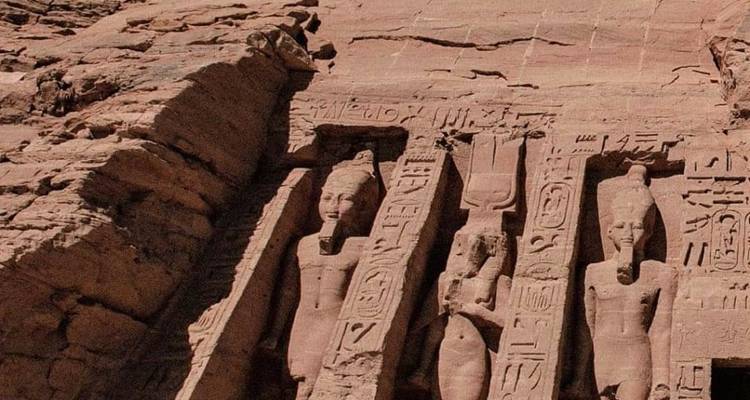 Steenbeeldhouwwerken van figuren op een rotswand, onderdeel van een tempelgevel.