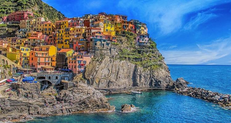 Colorful coastal village on rocky cliffs.