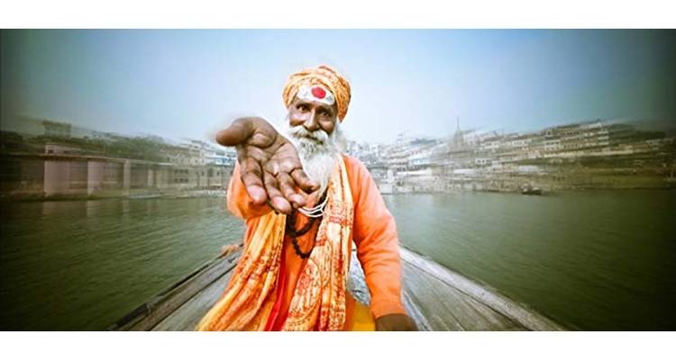 Portrait of a person on a boat with outstretched hand.