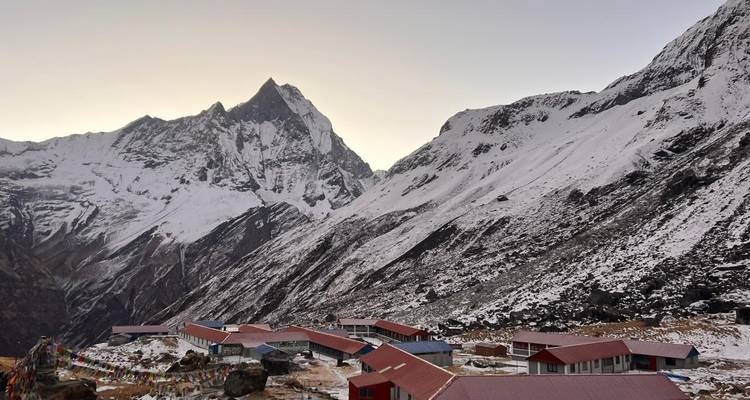 Snow-capped mountains and a lodge at Annapurna Base Camp.