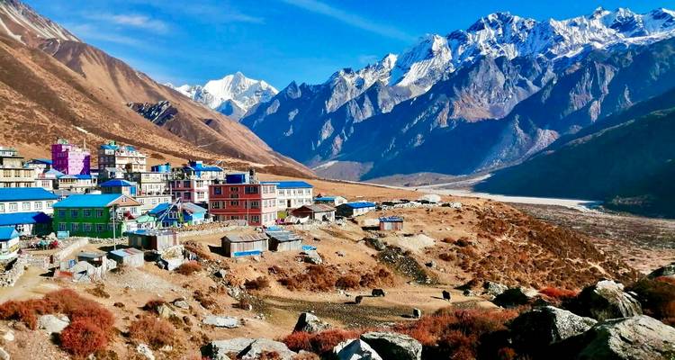 View of a colorful mountain village surrounded by rugged peaks.