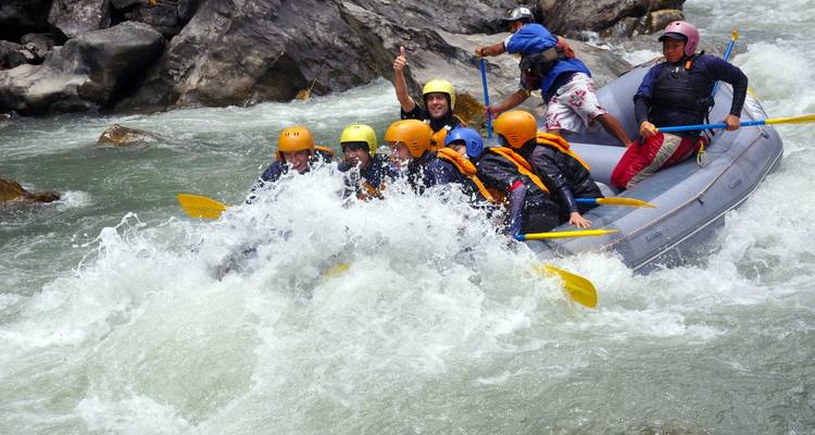 A group of people rafting through a rocky river.