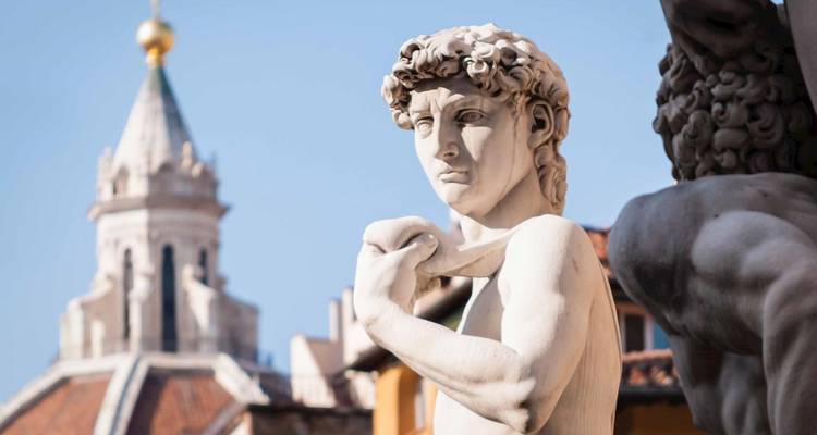 Statue of David with a building in the background in Florence.