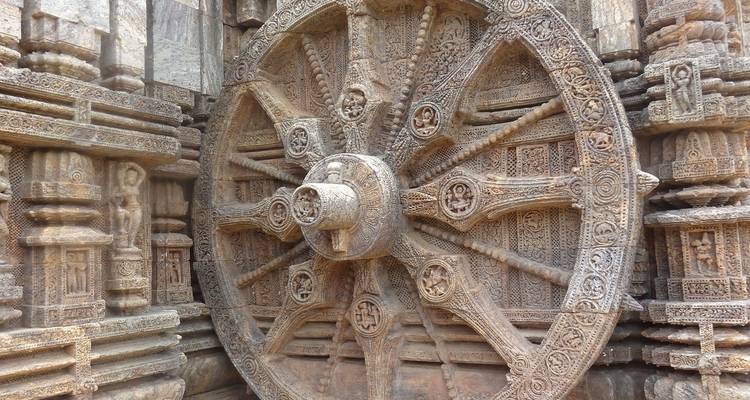 Intricate stone carvings on a large wheel.