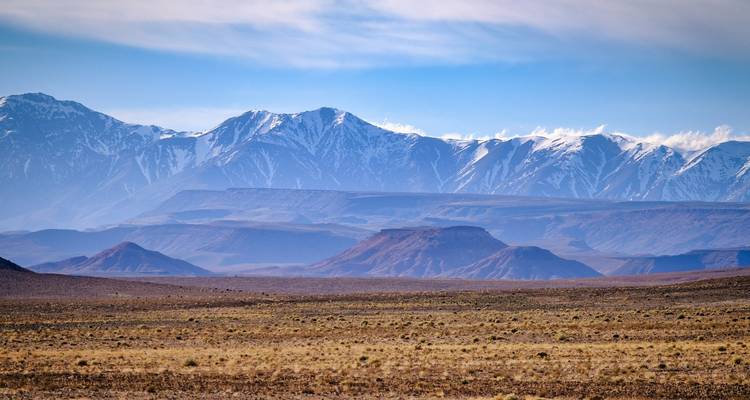 Mountain range with clear sky and layered rock formations.
