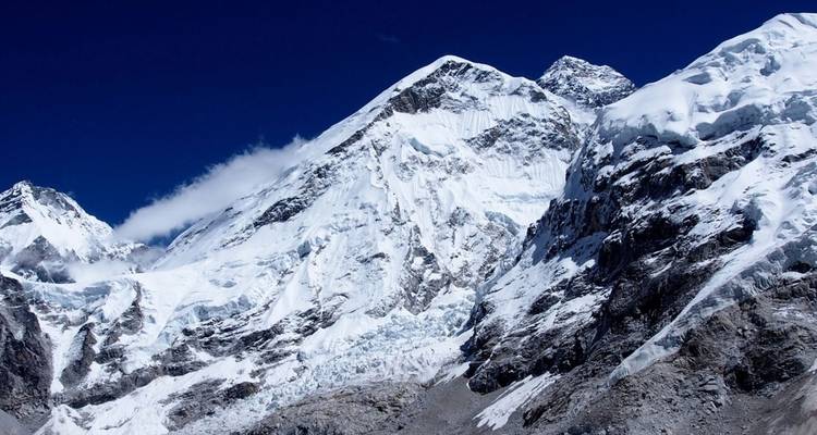 Snow-covered mountain peak under a clear blue sky.