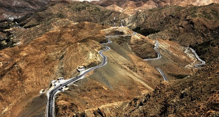 A winding road through a mountainous desert landscape.