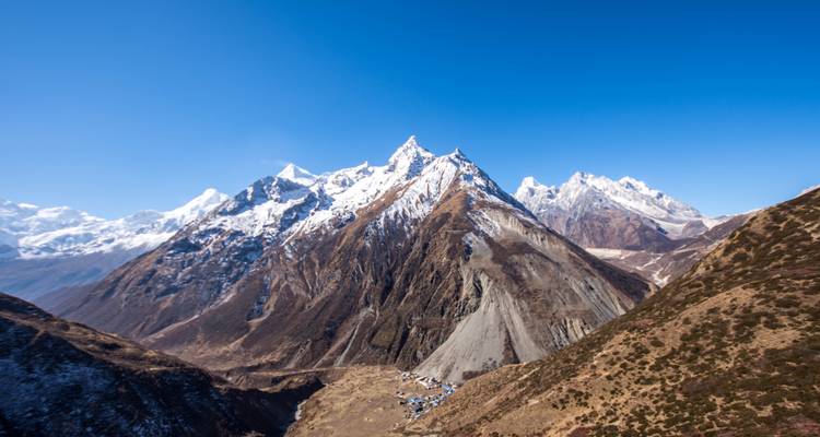 Snow-capped mountains with a clear sky and valley view.