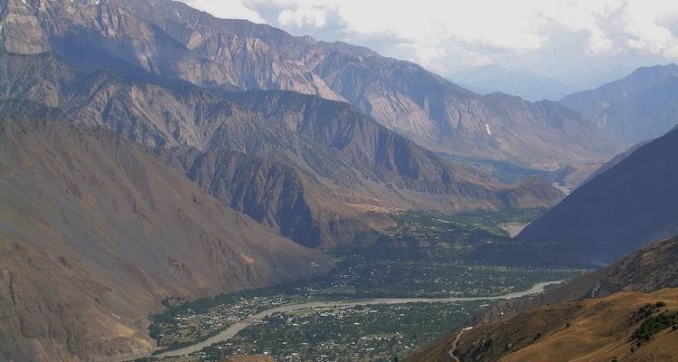 Scenic view of a valley with mountains and a river.