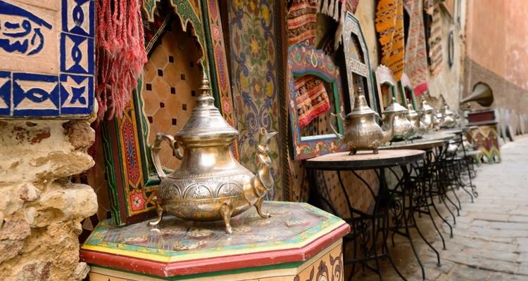 Decorative silver teapots and colorful textiles