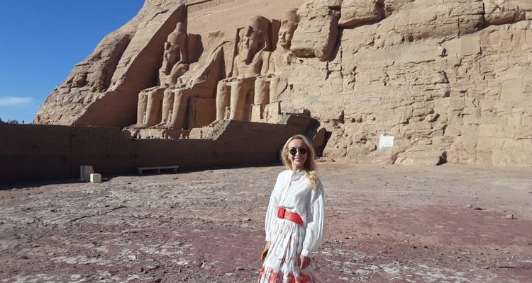 Woman standing in front of ancient Egyptian statues.
