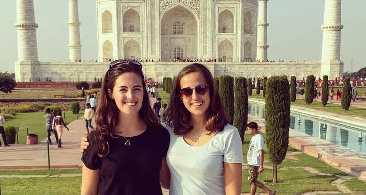 Twee mensen poseren voor de Taj Mahal.