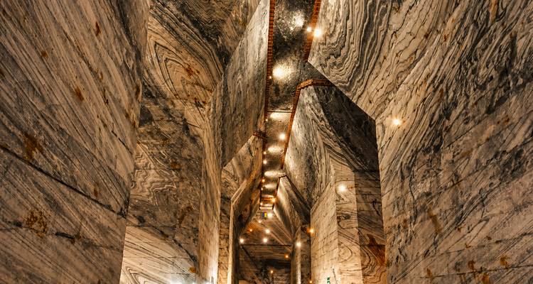 Abstract ceiling view of streaked salt walls and lights inside a cavern.