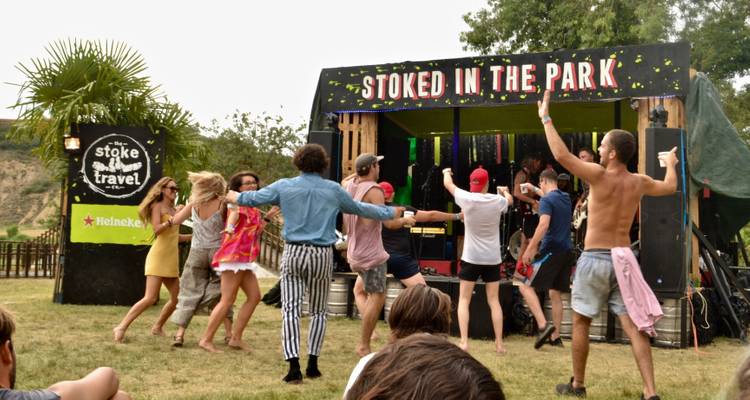 Des gens qui dansent devant une scène pendant un festival.