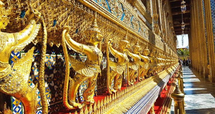 Golden ornate decorations on the walls of a temple.