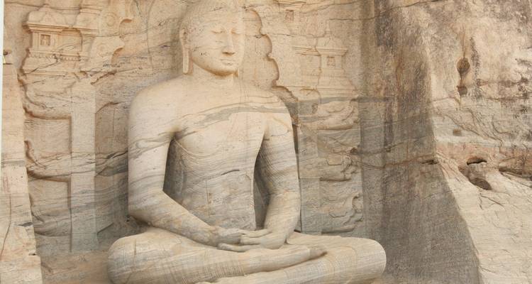 Large stone Buddha statue in a meditative pose.