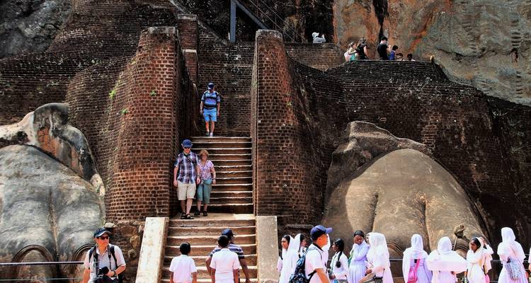 Historical site with visitors climbing stairs.