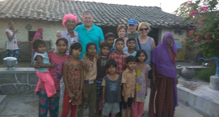 Group of people posing with local villagers.