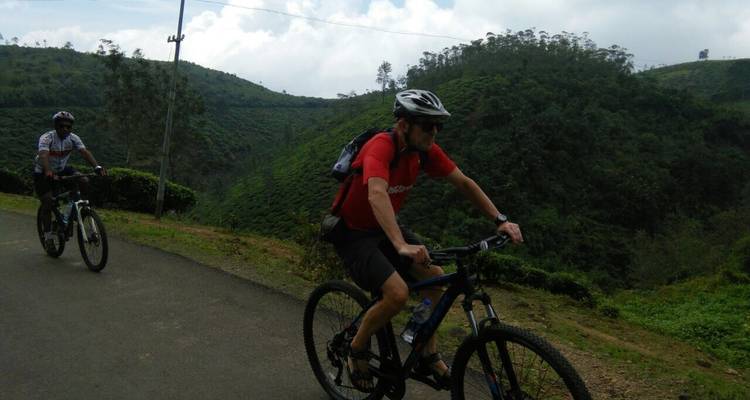 Two cyclists biking in a mountainous region.