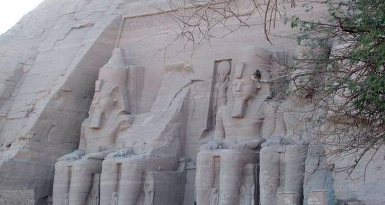 Two colossal seated statues of Ramses at Abu Simbel.