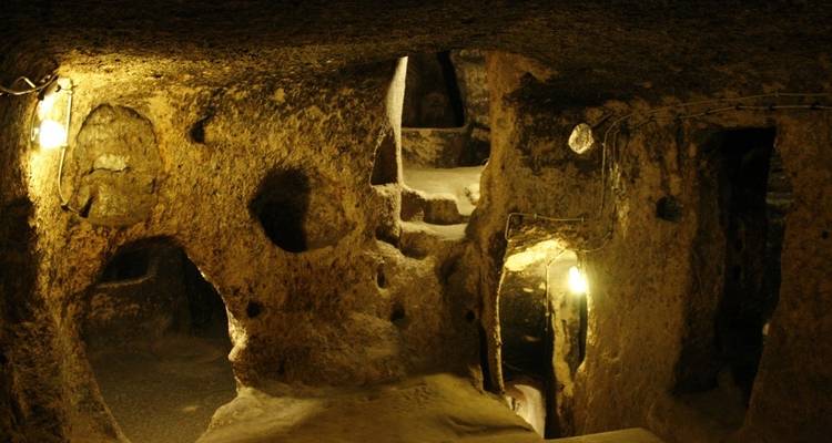 Underground cave with lit pathways.