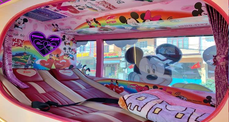 Colorful bus interior decorated with thematic cartoon murals.