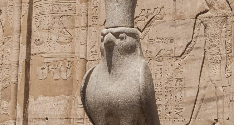 Sculpture of a falcon with Egyptian hieroglyphs.