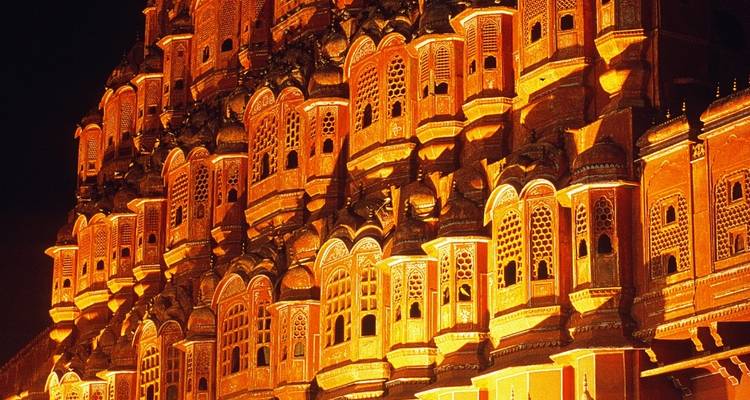 The Hawa Mahal illuminated at night.