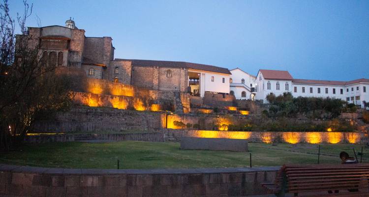 Illuminated historic building complex in the evening.