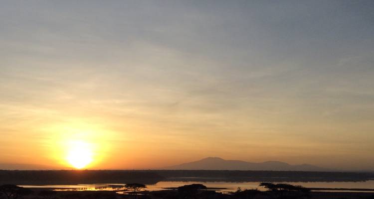 Sunrise over a landscape with distant hills.