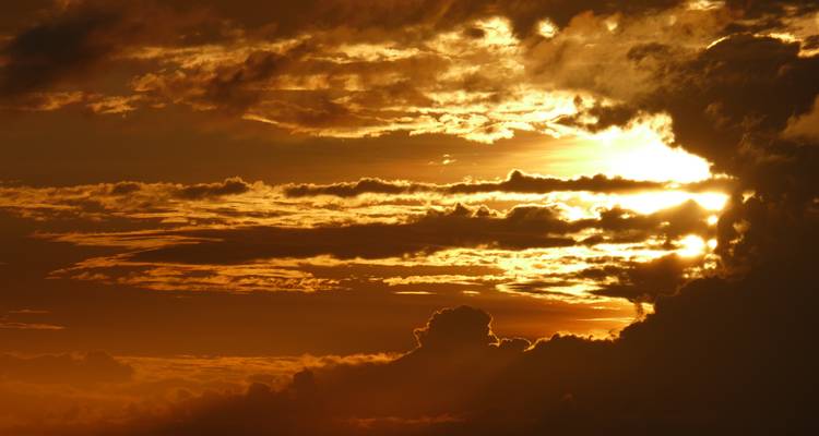 Close-up of vibrant sunset with dramatic clouds.