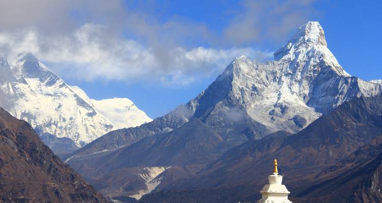 Majestic mountain range with a stupa in the foreground.