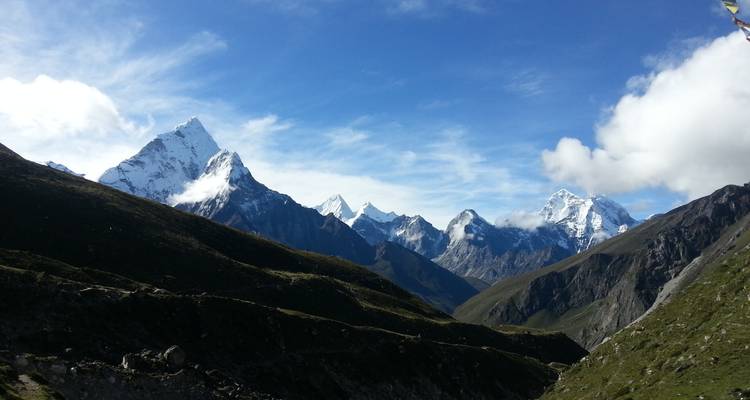 Panoramic view of snow-capped mountains under a clear sky.