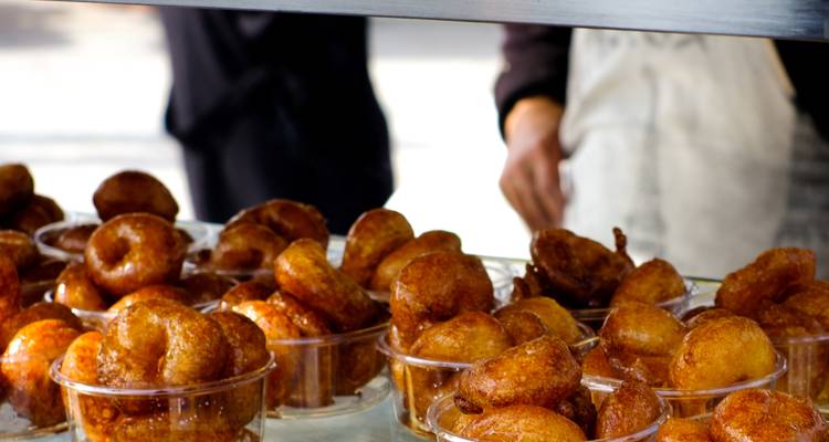 Tray of golden-brown pastries displayed on a counter.