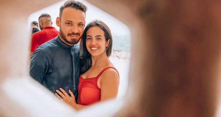 Couple posing through an artistic window frame.