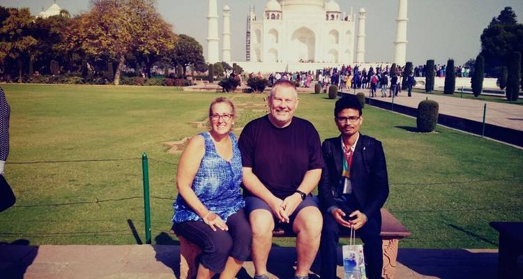 Tourists sitting in front of the Taj Mahal.
