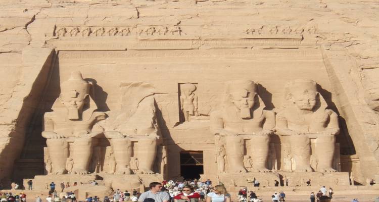 Les touristes visitant les statues monumentales en pierre d'Abou Simbel.