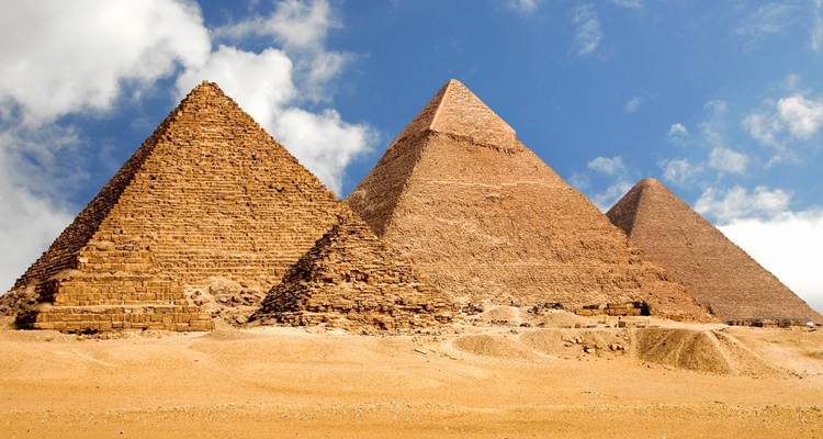 The Pyramids of Giza against a bright, clear sky.