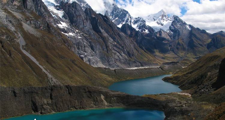 Mountainous landscape with two lakes and snowy peaks.