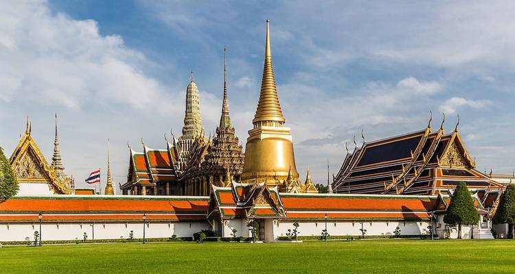The Grand Palace in Bangkok with its ornate architecture and lush gardens.