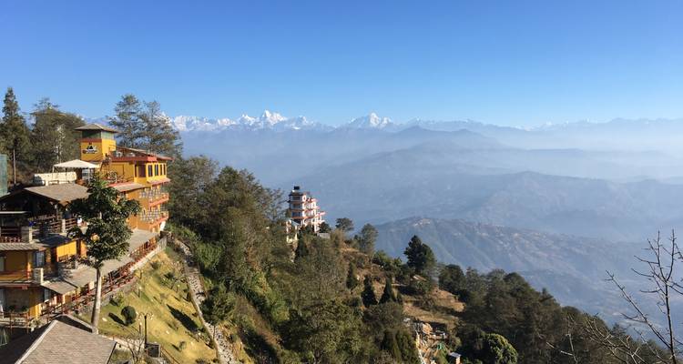 Landscape view of mountains and buildings with clear blue sky.