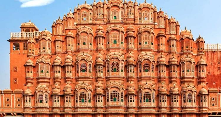 Elaborate red sandstone palace facade with numerous windows.