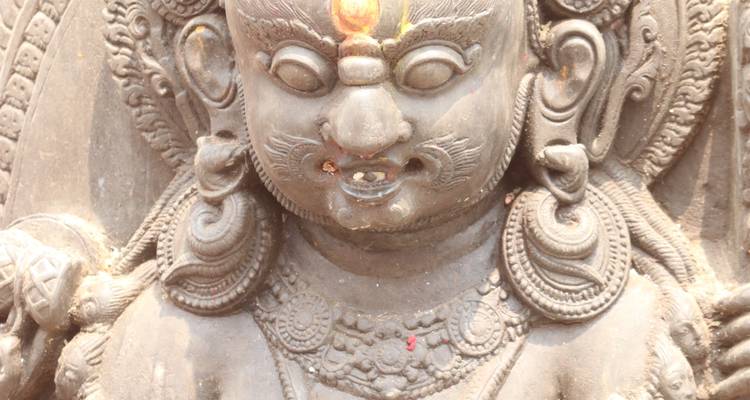 Close-up of detailed stone carving of a deity.