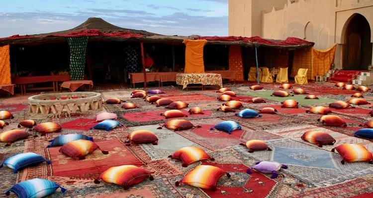 Colorful seating arrangement in a desert camp.