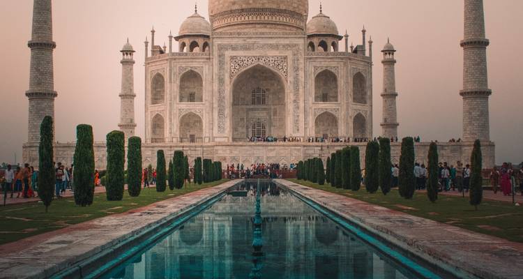 Front view of the Taj Mahal with reflection on the water.