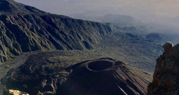 View of a volcanic crater and rugged landscape.