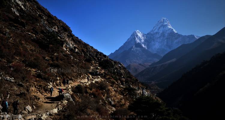 Trail with mountains in the background, watermark present.