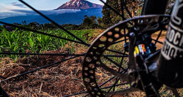 Bicycle wheel foreground with a mountain in the distance.