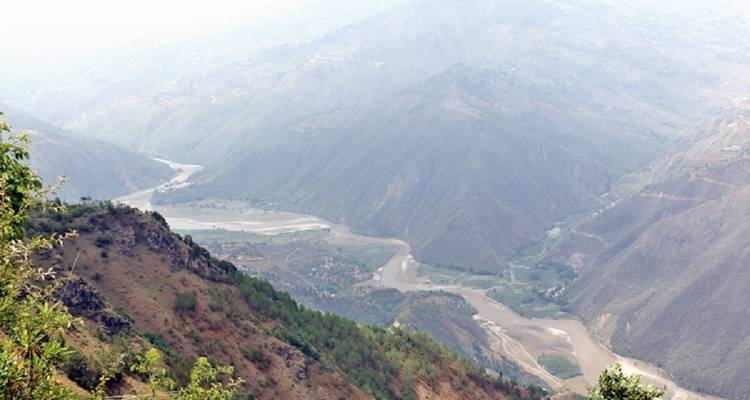 Aerial view of a river winding through hilly terrain.